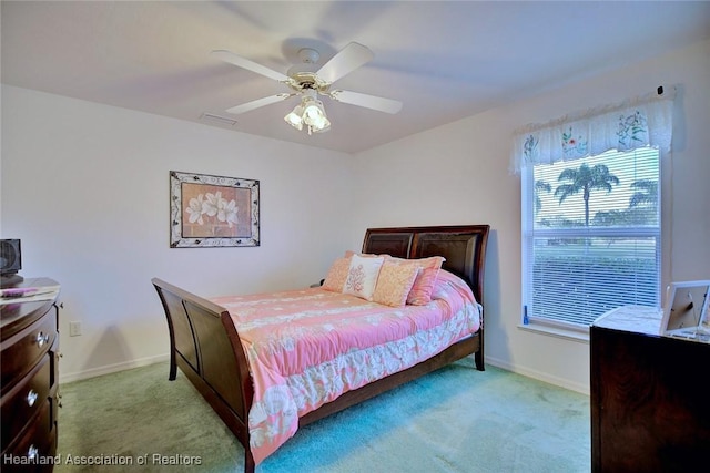 bedroom with ceiling fan and light carpet