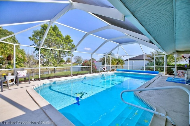 view of swimming pool with a patio and glass enclosure