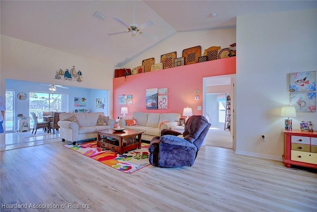 living room featuring ceiling fan, high vaulted ceiling, and light hardwood / wood-style flooring