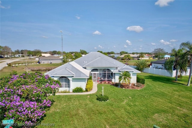 view of front of property with a lanai and a front lawn