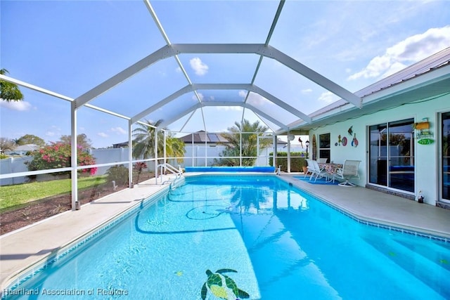 view of swimming pool with a patio area and glass enclosure