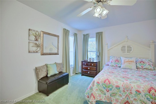 bedroom with light colored carpet and ceiling fan