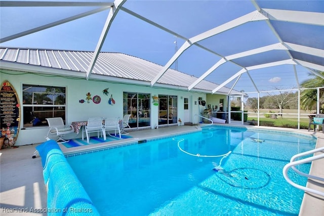 view of swimming pool featuring a lanai and a patio