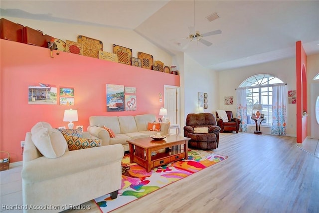 living room featuring lofted ceiling, light hardwood / wood-style flooring, and ceiling fan