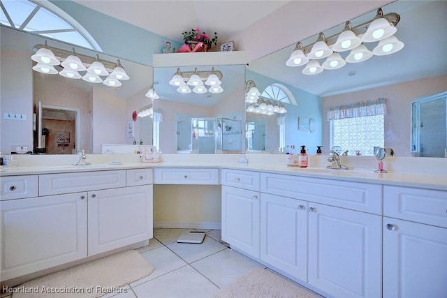 bathroom with vanity, tile patterned floors, vaulted ceiling, and a shower with door