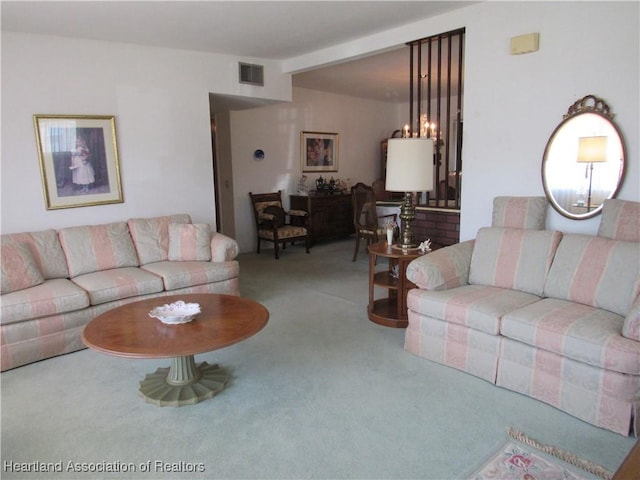 carpeted living room with a chandelier and visible vents