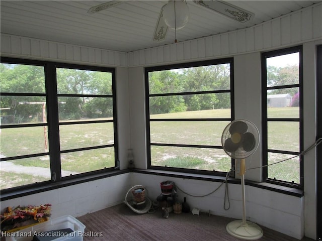 sunroom with a ceiling fan and a wealth of natural light