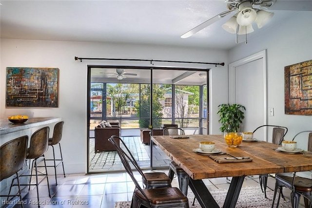dining room featuring light tile patterned floors and a ceiling fan