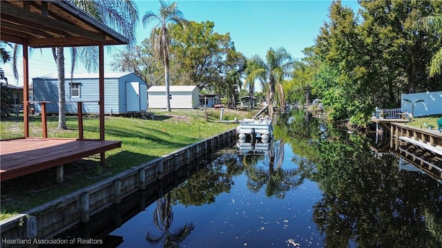 view of dock featuring a water view and a lawn
