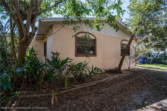 view of side of property with stucco siding