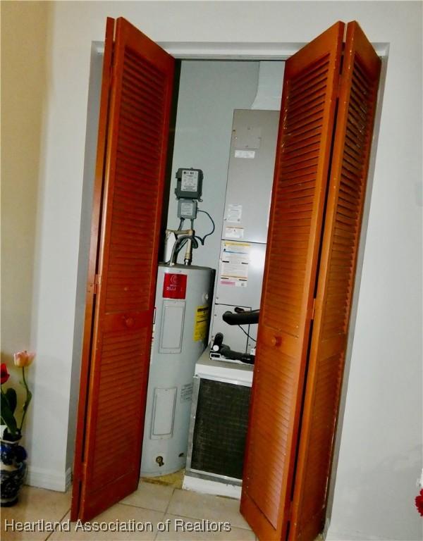 utility room with electric water heater