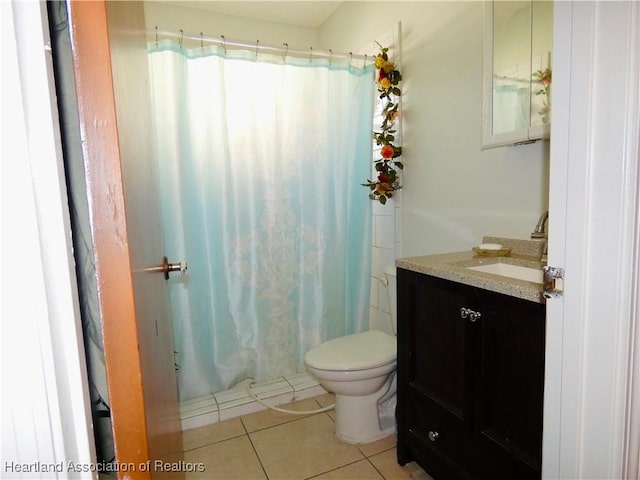 bathroom with toilet, vanity, a shower with shower curtain, and tile patterned flooring