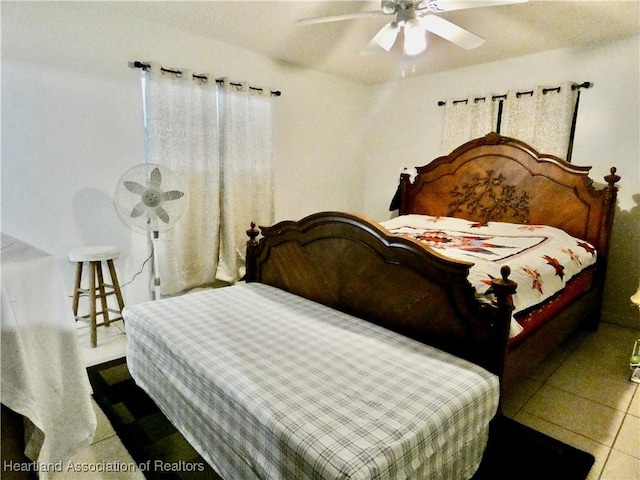 tiled bedroom featuring a ceiling fan