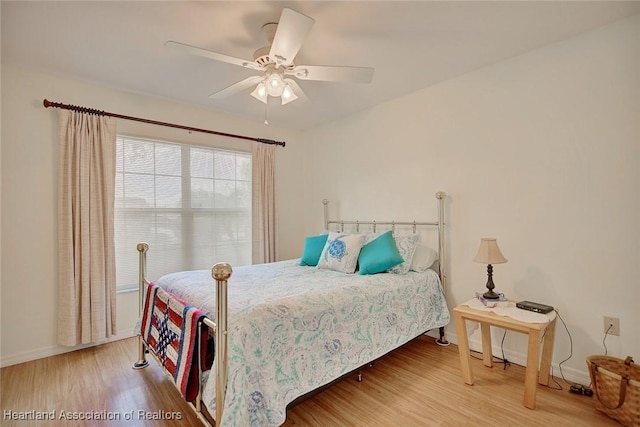 bedroom with hardwood / wood-style flooring and ceiling fan