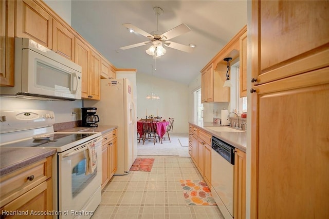 kitchen featuring decorative light fixtures, white appliances, sink, and vaulted ceiling