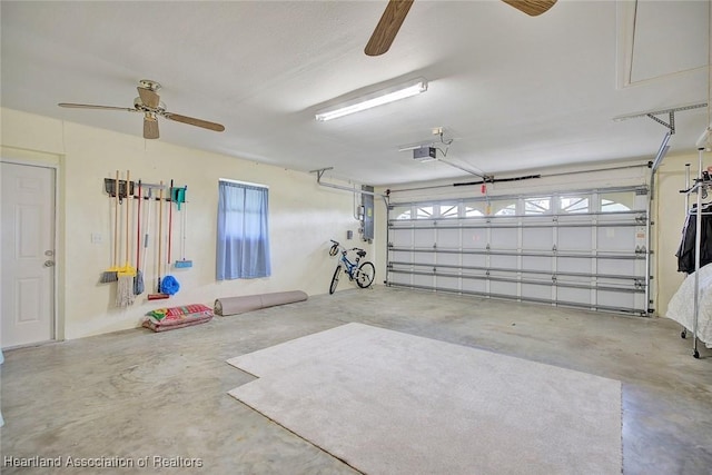 garage featuring ceiling fan and a garage door opener