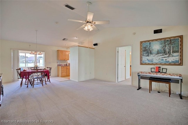 carpeted living room featuring ceiling fan and lofted ceiling