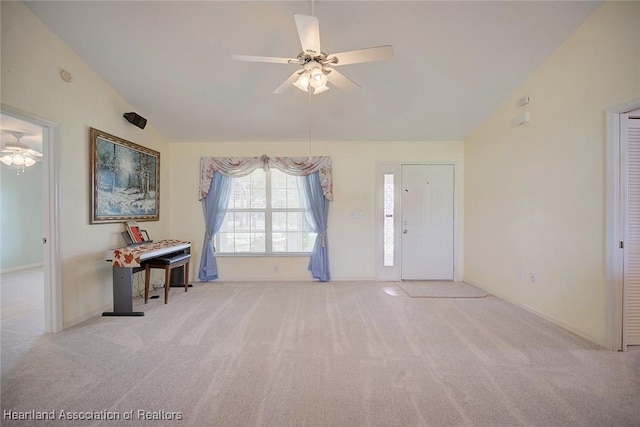 interior space with ceiling fan and vaulted ceiling