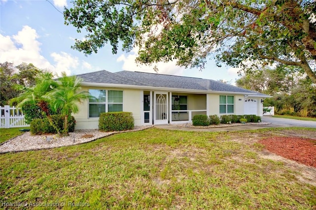 single story home with a front yard and a garage