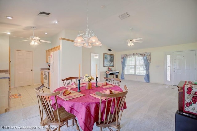 carpeted dining space with lofted ceiling and ceiling fan with notable chandelier