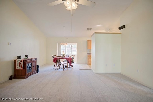 interior space featuring ceiling fan with notable chandelier