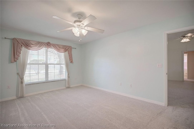 unfurnished room with ceiling fan and light colored carpet