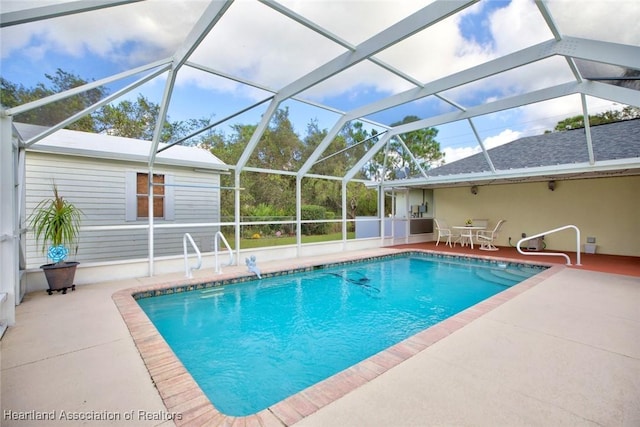 view of pool featuring a patio area and glass enclosure