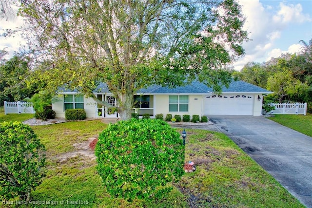 ranch-style house with a garage and a front lawn