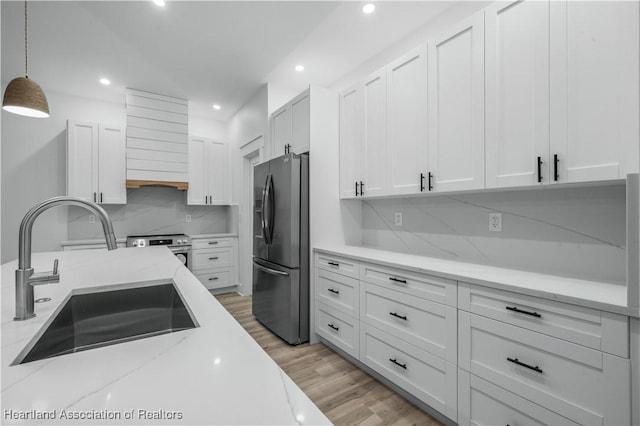 kitchen featuring white cabinetry, sink, and fridge with ice dispenser