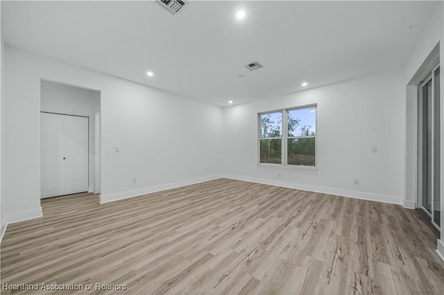 empty room with light hardwood / wood-style floors