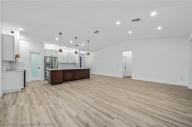 kitchen with decorative light fixtures, white cabinetry, a center island, stainless steel refrigerator with ice dispenser, and light hardwood / wood-style flooring