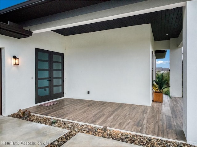 entrance to property with french doors and a wooden deck