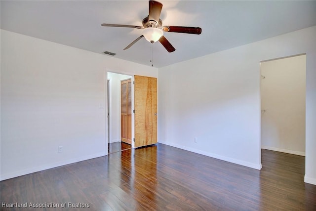 unfurnished room featuring dark hardwood / wood-style flooring and ceiling fan