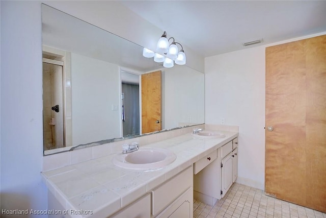 bathroom featuring vanity, an enclosed shower, and an inviting chandelier