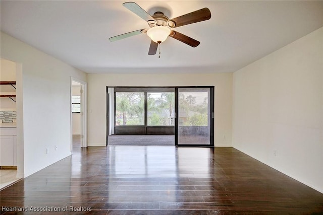 unfurnished room featuring ceiling fan and dark hardwood / wood-style flooring