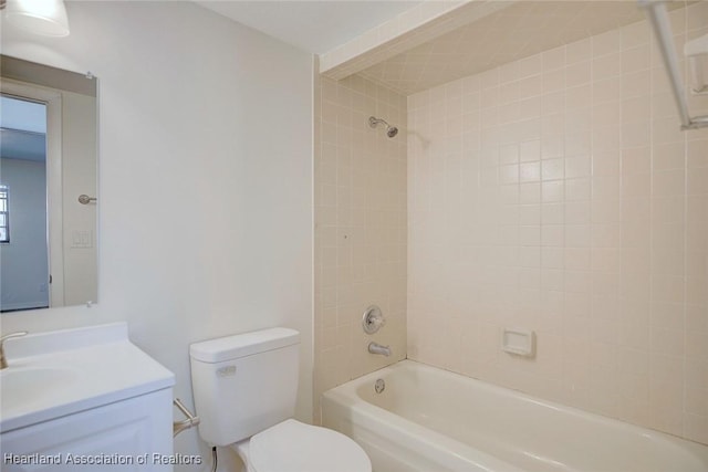 full bathroom featuring vanity, toilet, and tiled shower / bath combo