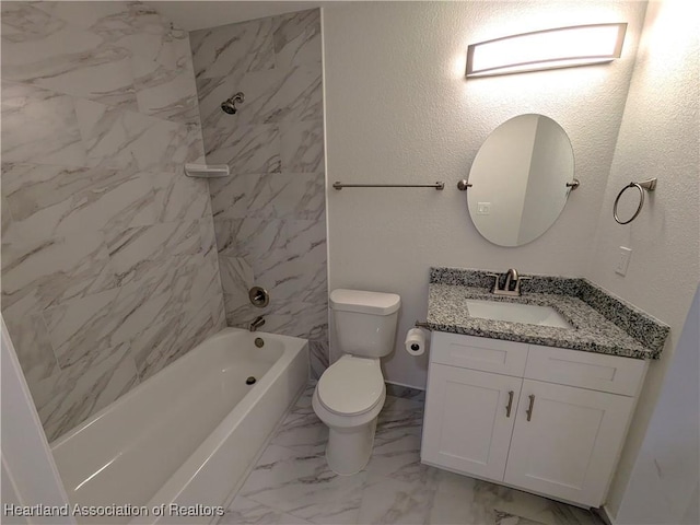 full bathroom featuring toilet, tiled shower / bath, and vanity