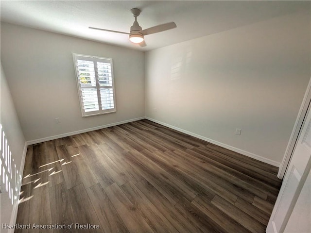 spare room featuring ceiling fan and dark hardwood / wood-style floors