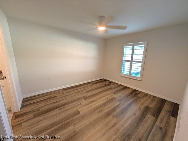 unfurnished room featuring ceiling fan and wood-type flooring