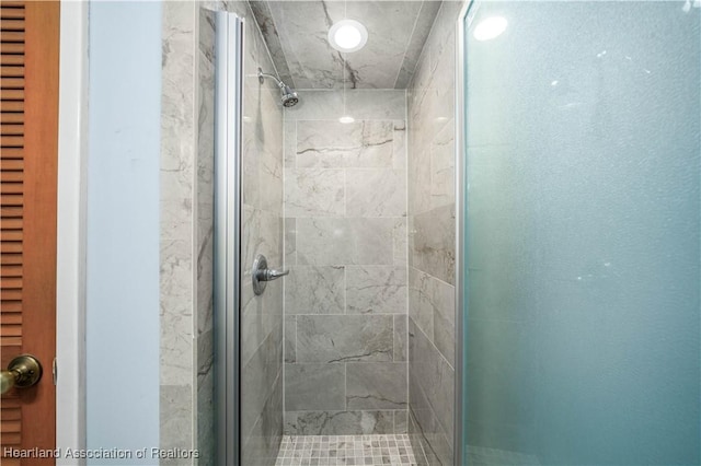 bathroom featuring a shower with shower door