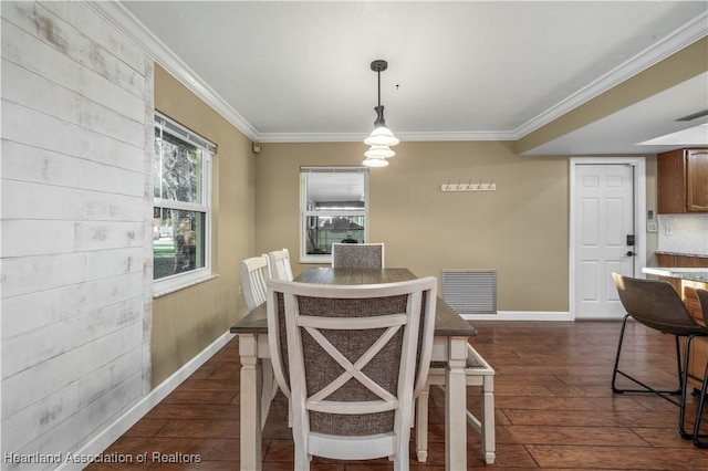 dining area with dark hardwood / wood-style floors and ornamental molding