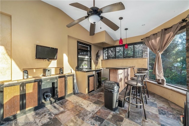 view of patio / terrace with area for grilling, ceiling fan, and exterior bar