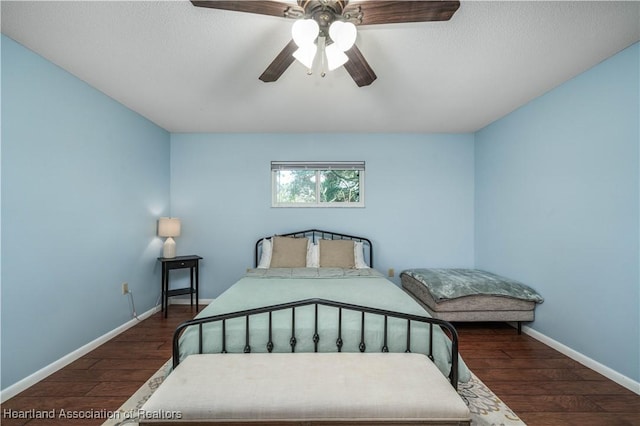 bedroom with ceiling fan and dark hardwood / wood-style floors