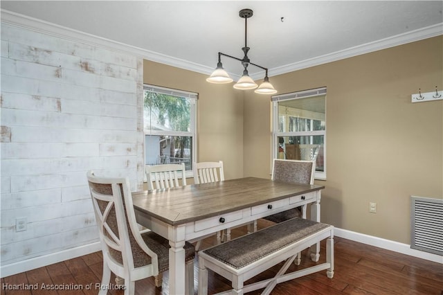 dining room with dark hardwood / wood-style flooring and ornamental molding