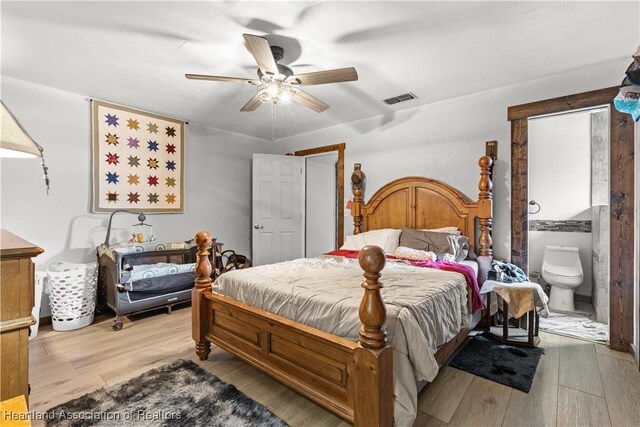 513 Serenade Ter, Lake Placid, FL 33852 - bedroom featuring wood finished floors, ceiling fan, and ensuite bathroom