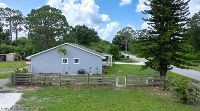 513 Serenade Ter, Lake Placid, FL 33852 - back of property featuring stucco siding, a patio area, and a shingled roof