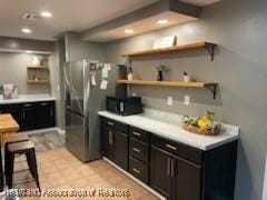 300 Whatley Blvd, Sebring, FL 33870 - kitchen featuring open shelves, freestanding refrigerator, black microwave, recessed lighting, and light countertops