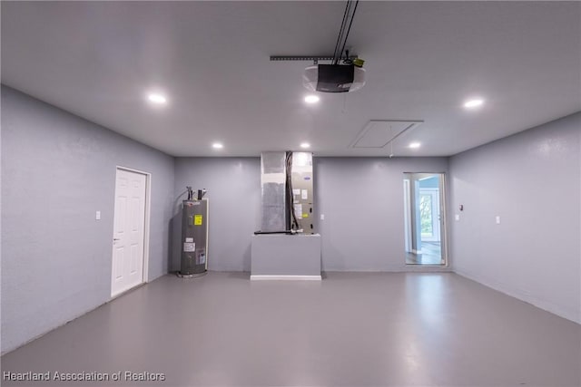 garage with heating unit, water heater, and a garage door opener