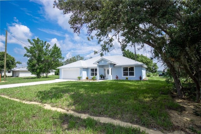 single story home with a front yard and a garage