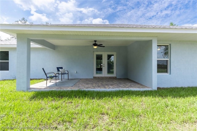 rear view of property with a lawn, ceiling fan, and a patio area